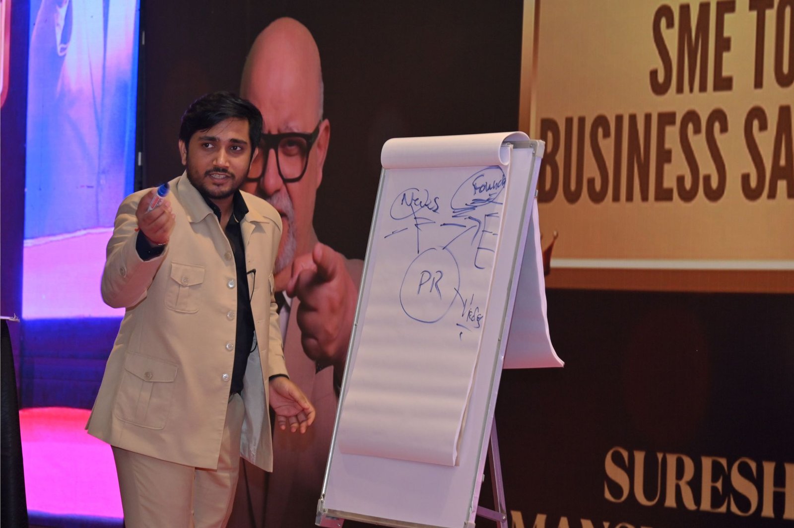 Durvesh speaking on stage